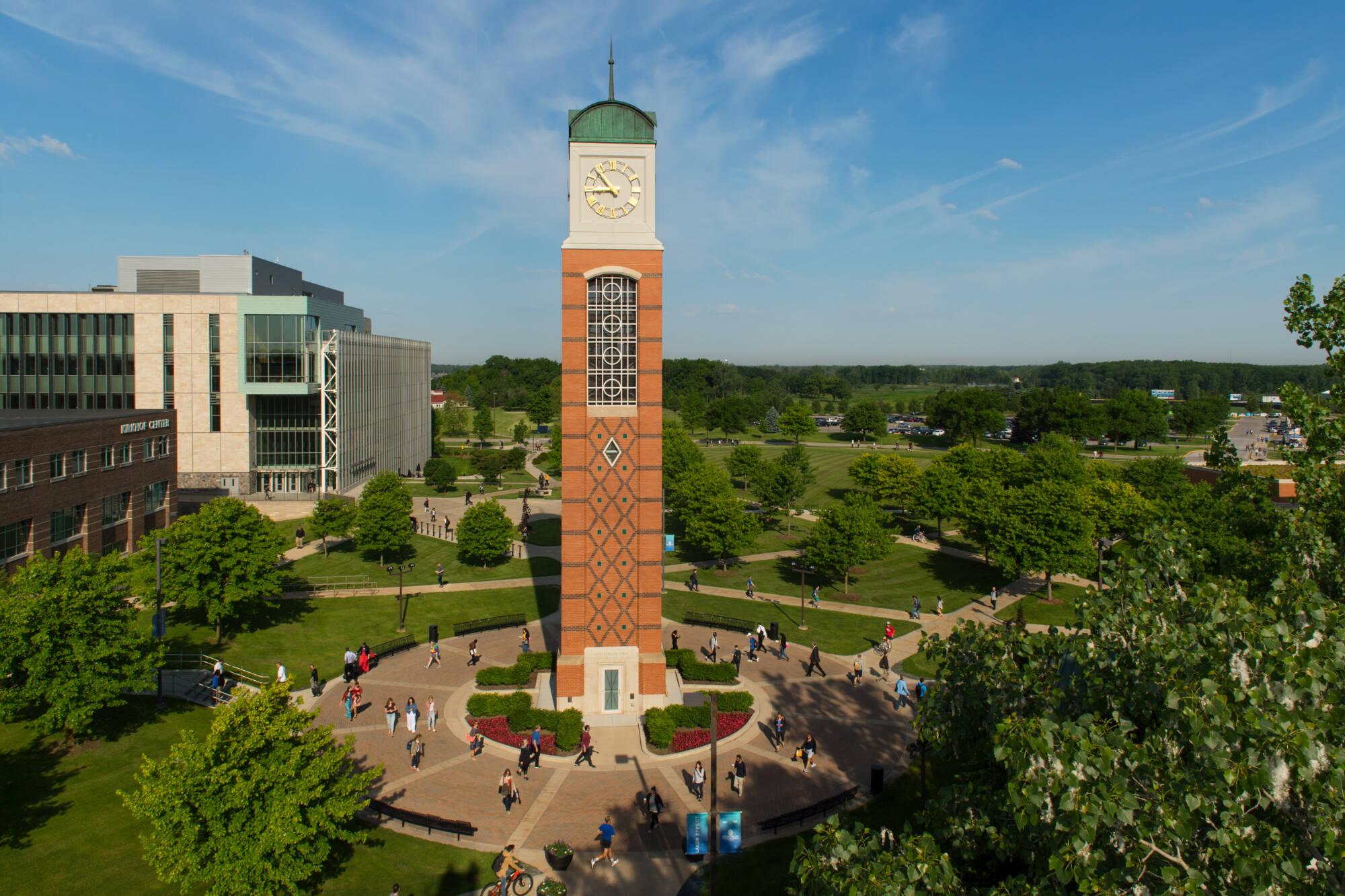 Arial of GVSU's Allendale campus, featuring a clock tower surrounded by sidewalks filled with students.